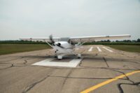 Small single-engine airplane aligned on a marked runway