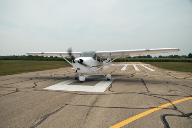 Small single-engine airplane aligned on a marked runway